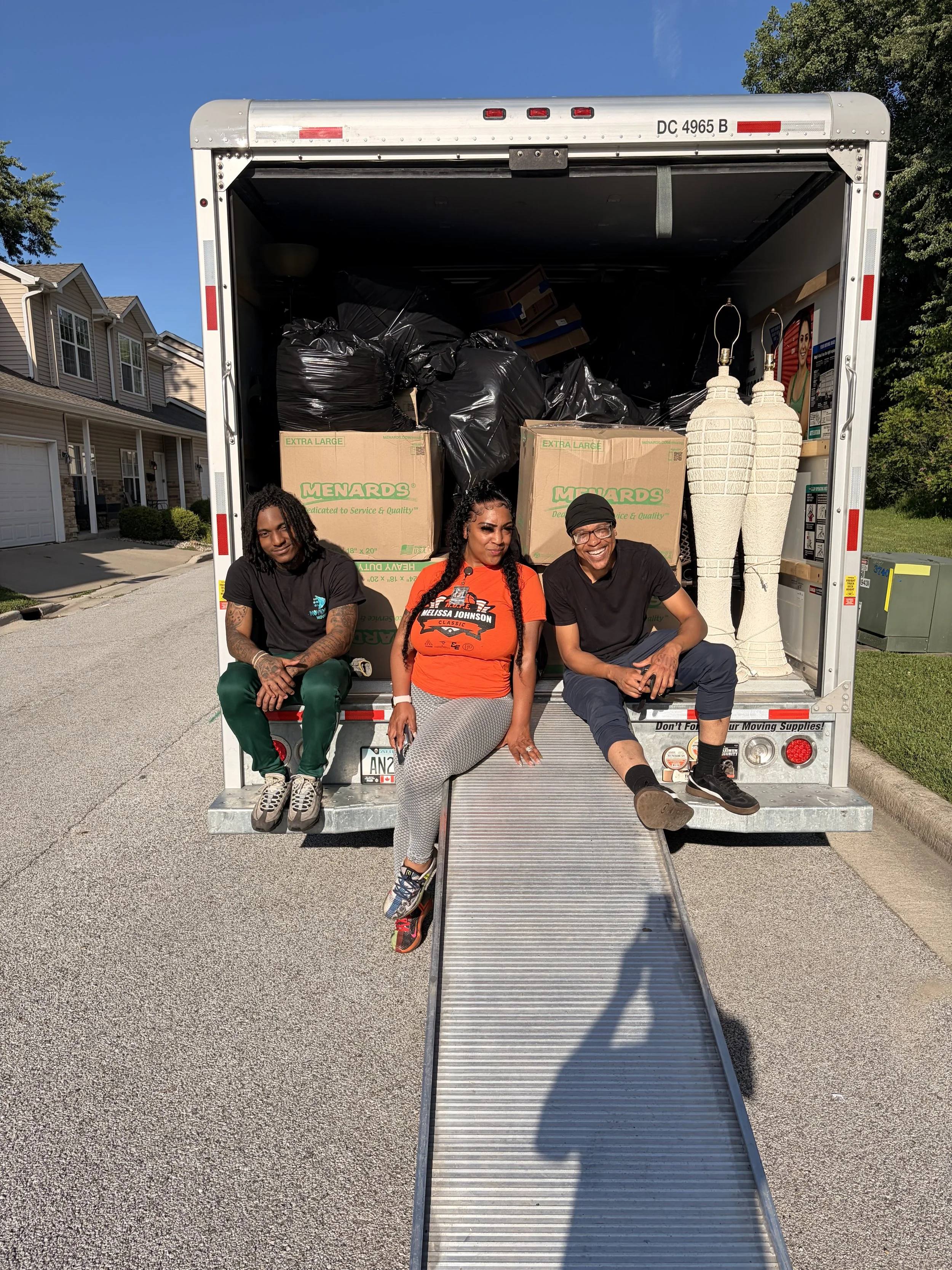 A photo of professional movers loading a 26’’ truck.