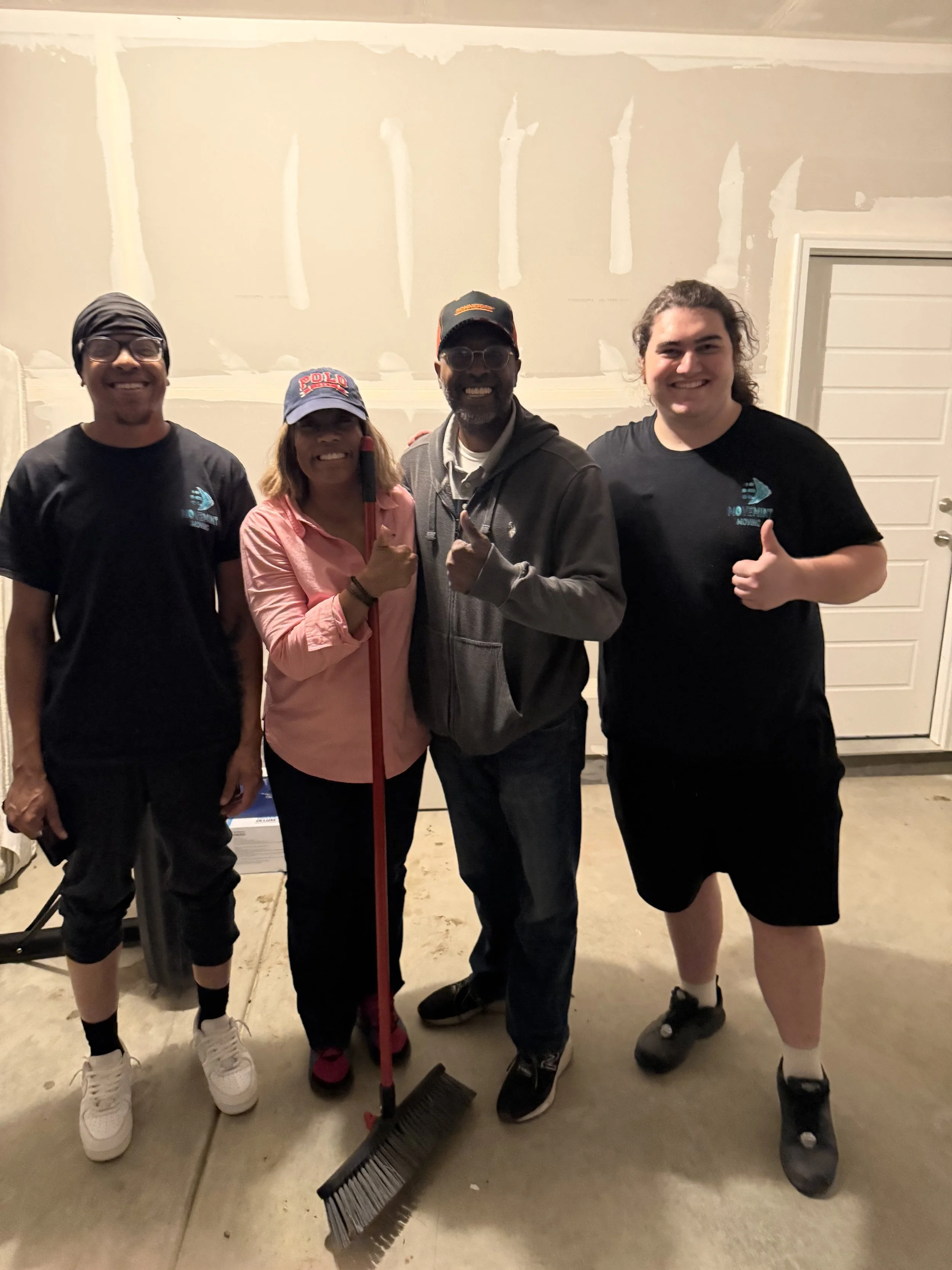 2 professional movers with a client after moving the clients marble table top.