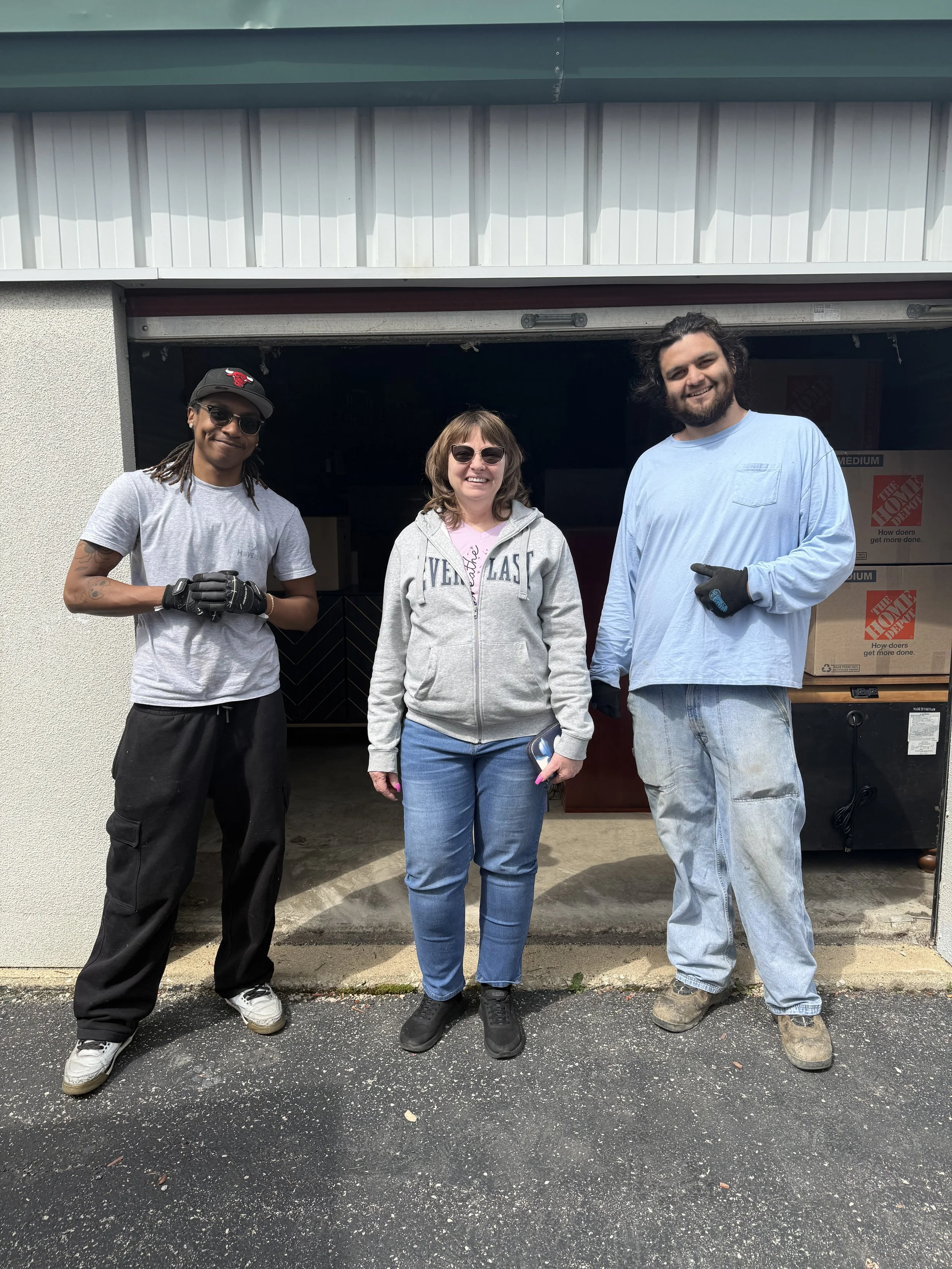 2 professional movers with a client after moving the clients marble table top.
