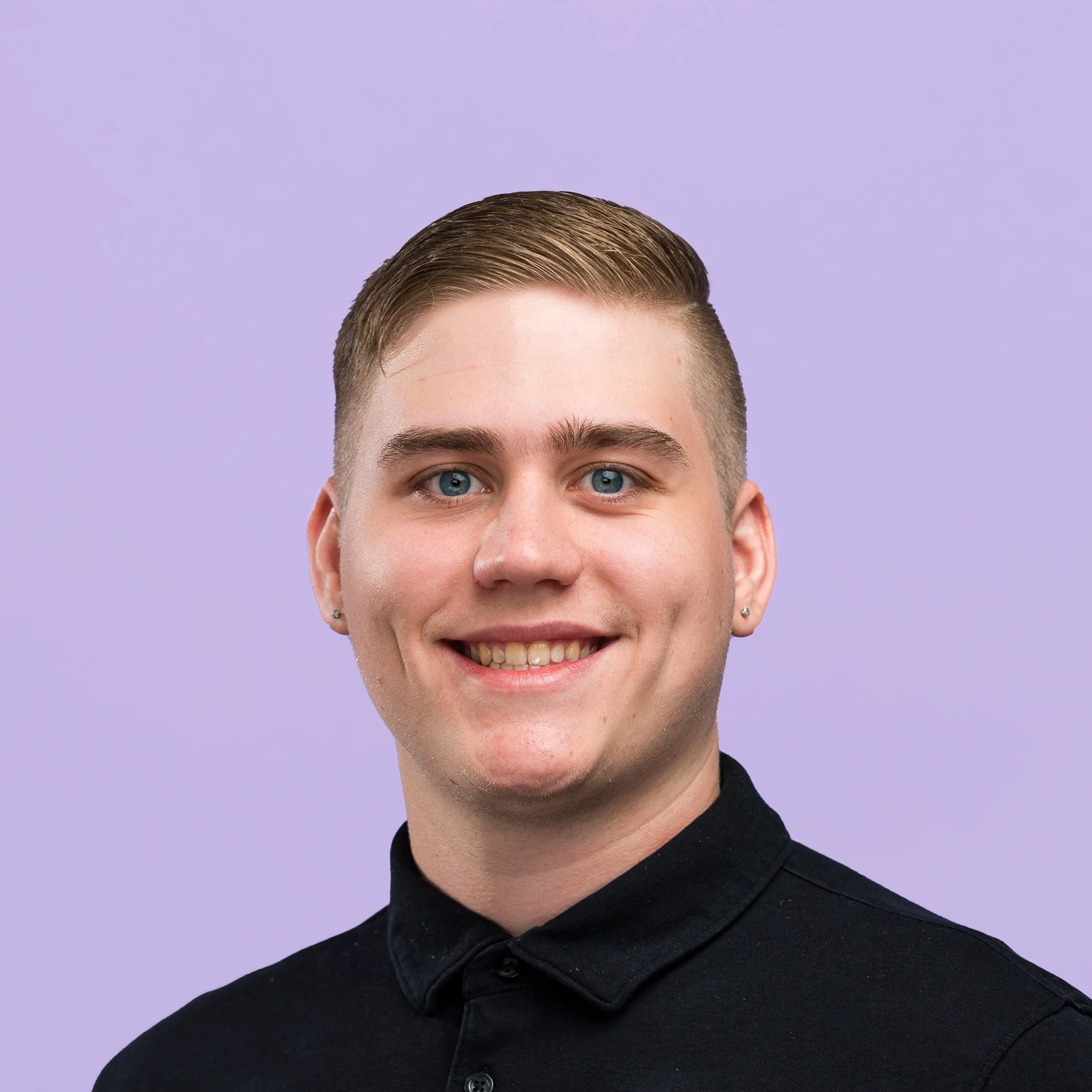 Conner Brian. Close-up of a young man with short, styled hair, wearing a black collared shirt, smiling against a purple background.