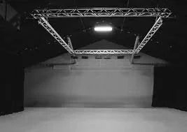 Empty indoor stage with lighting and rigging overhead