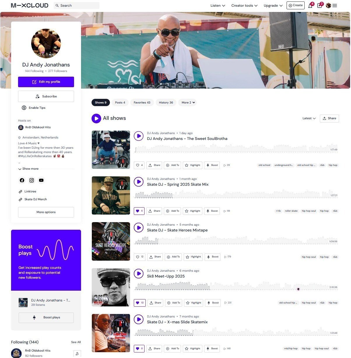 Screenshot of a DJ website featuring DJ Andy Jonathans performing outdoors with a bald man wearing sunglasses, a white towel around his neck, and a white shirt, smiling and pointing at the camera, against a colorful mural background.