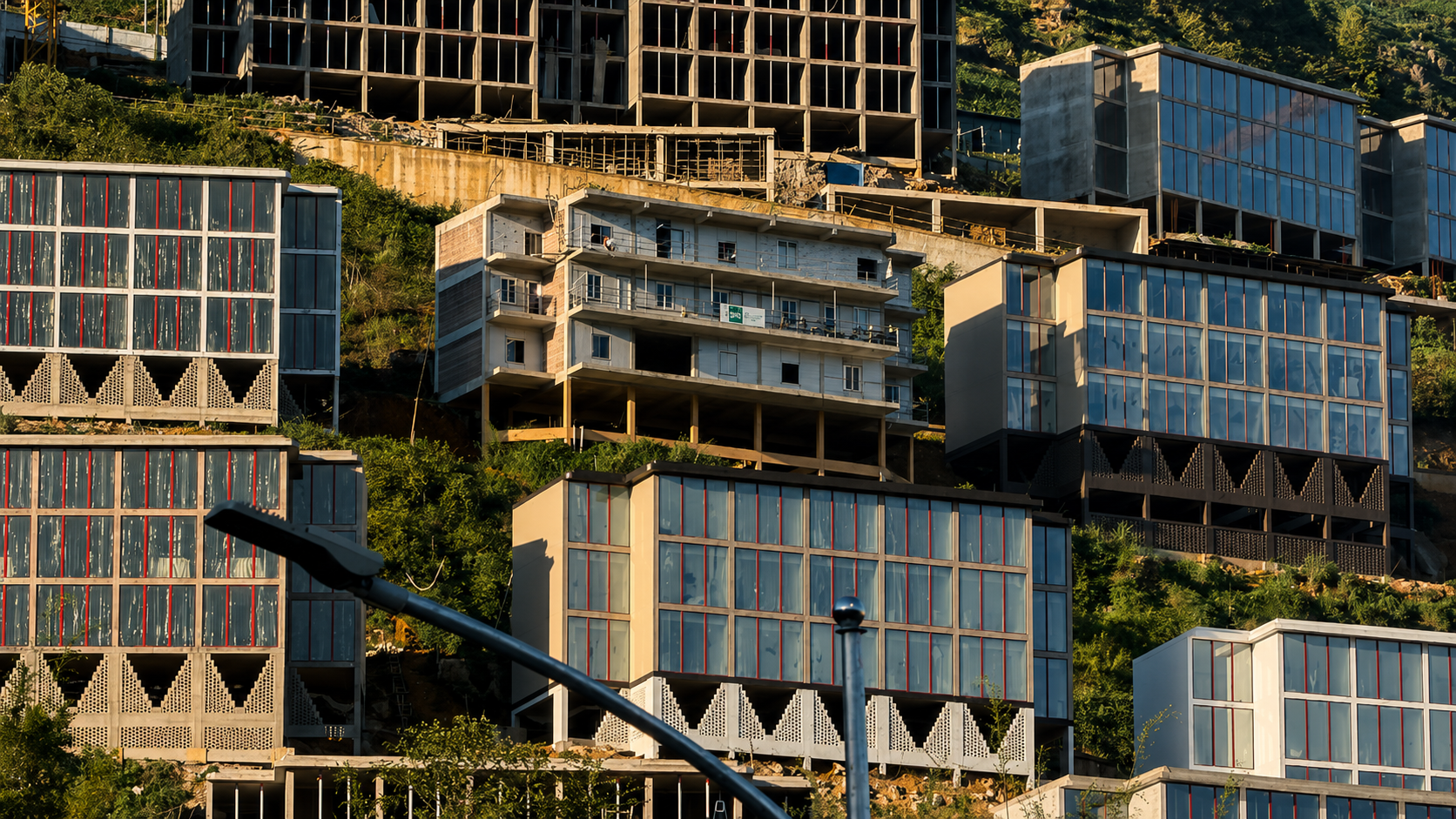 Modern multi-storey hotel developments built into the mountainsides above Sapa.