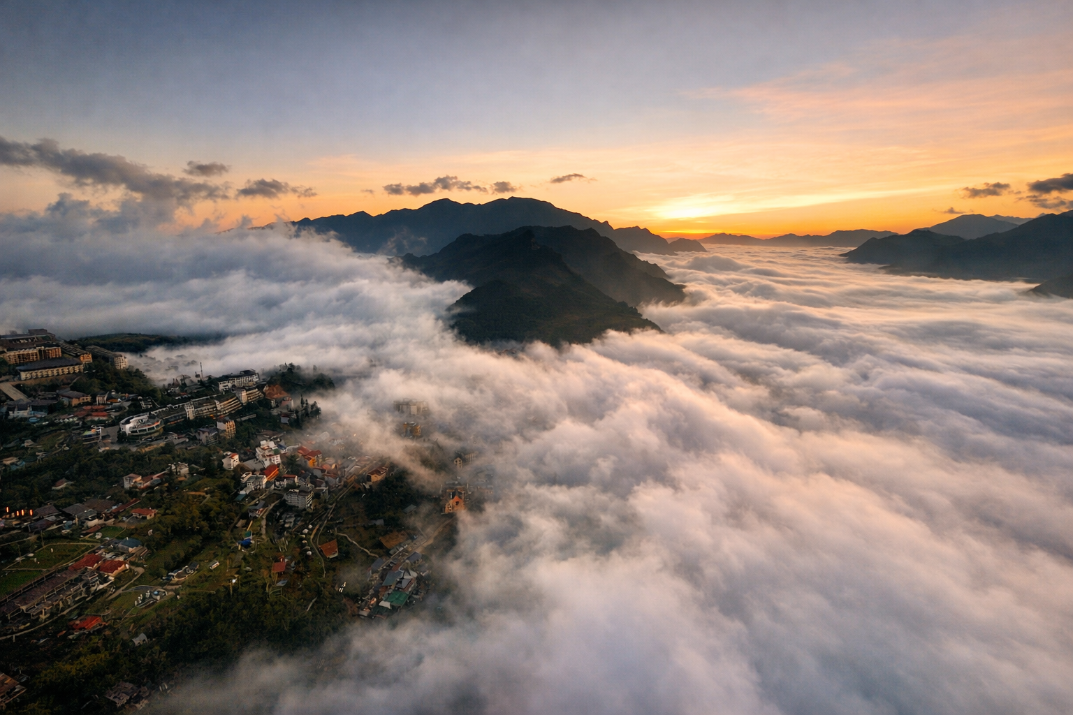 inversion.jpg Aerial view of Sapa town surrounded by mountain peaks and a dramatic sea of clouds at sunrise.