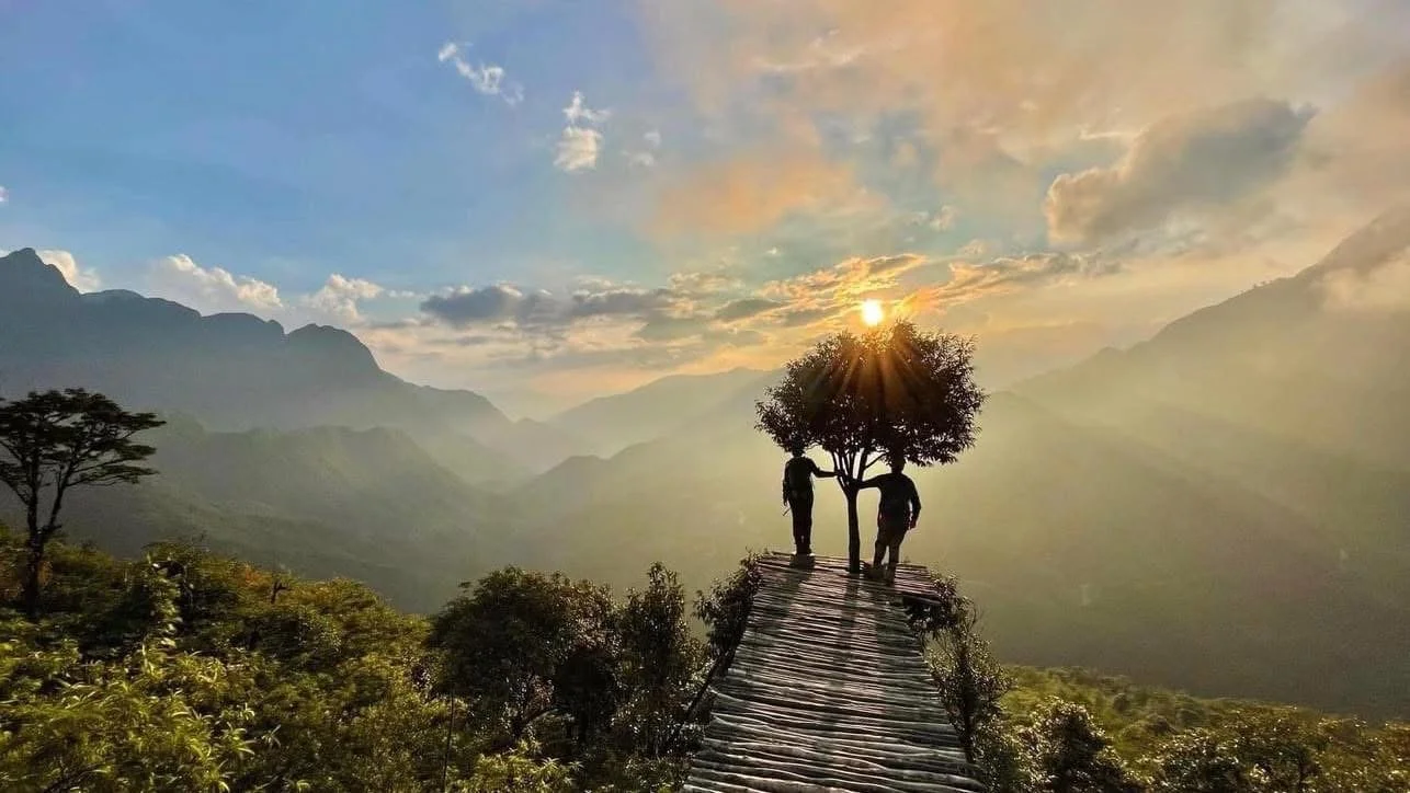 Mountain trail in Sapa at sunset with misty peaks and warm light, capturing the peaceful atmosphere of remote highland landscapes.