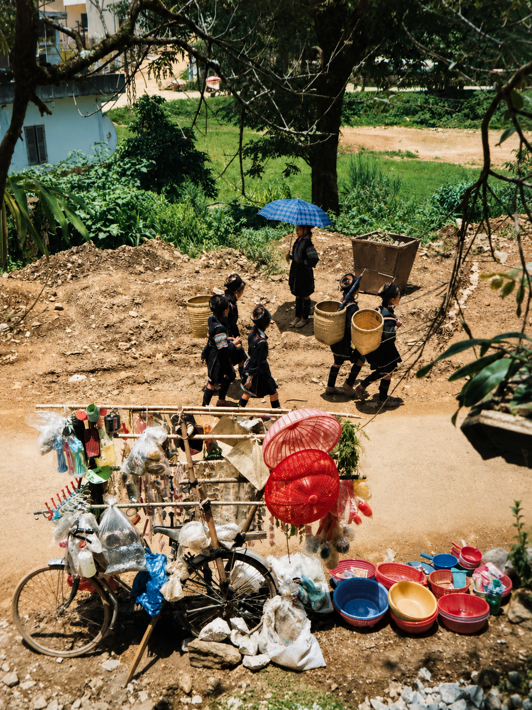 Families carrying woven baskets as they arrive at Sapa Market in northern Vietnam in 1998.