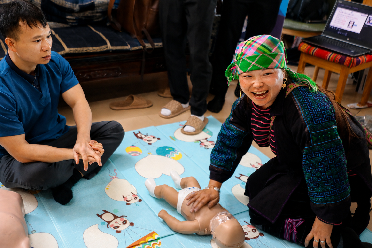 Hmong guide practicing CPR during first aid training at the ETHOS Community Centre.