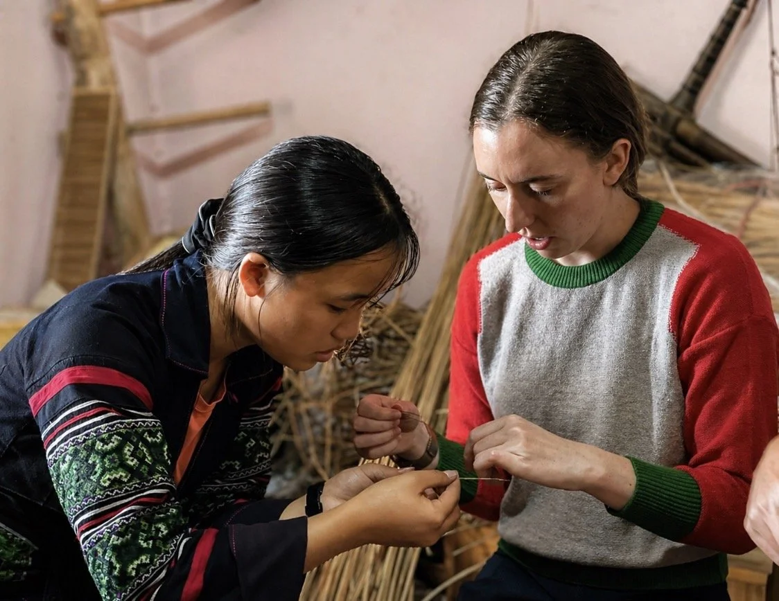 ETHOS Youth Leader Cha teaching traditional Hmong textile techniques to a visitor at the ETHOS Community Centre in Sa Pa, Vietnam.