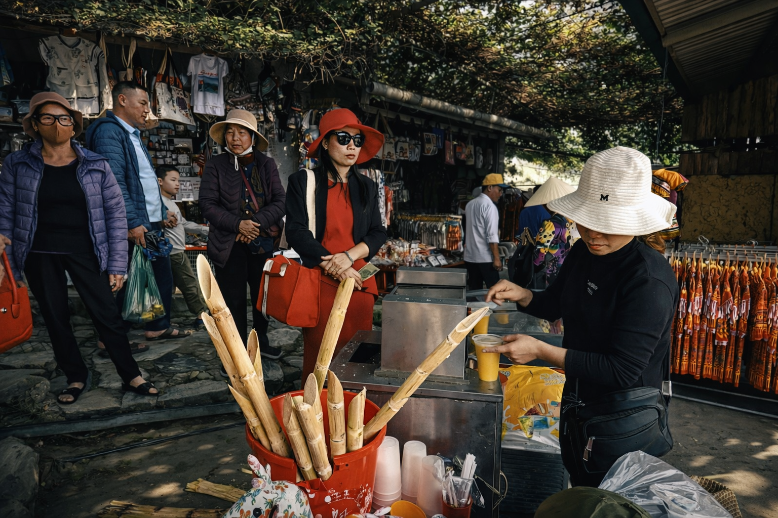 Visitors browsing snacks and machine-made souvenirs in Cat Cat Village, reflecting the commercialisation of Sapa’s most visited tourist site