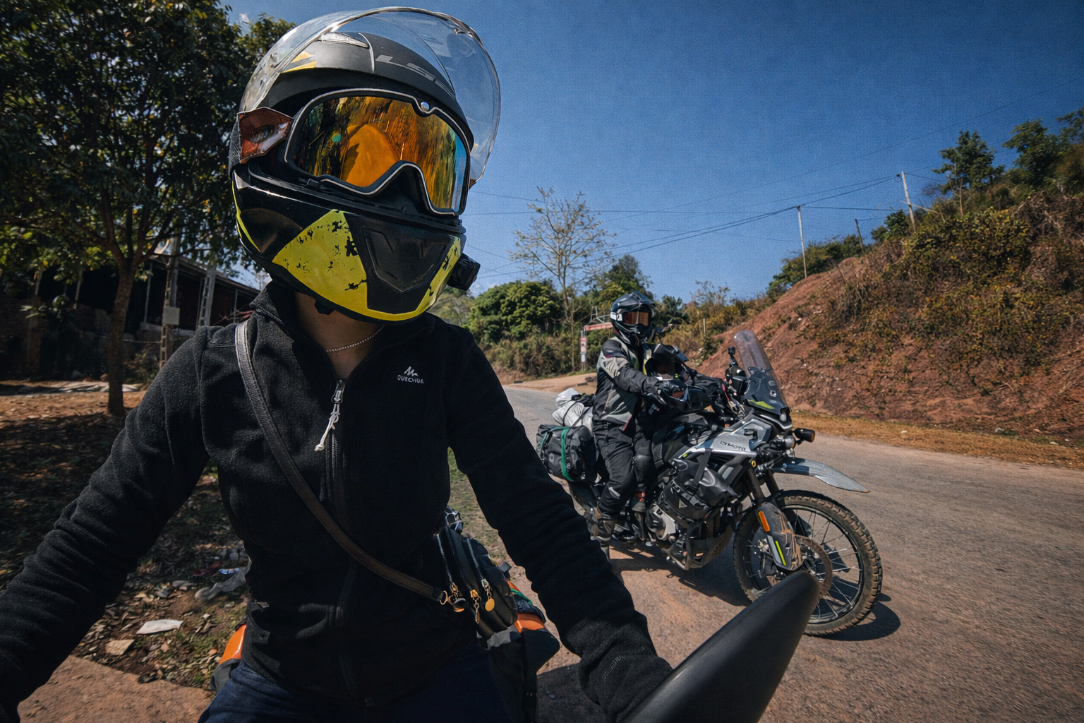 Motorbike rider travelling along a winding mountain road in northern Vietnam.