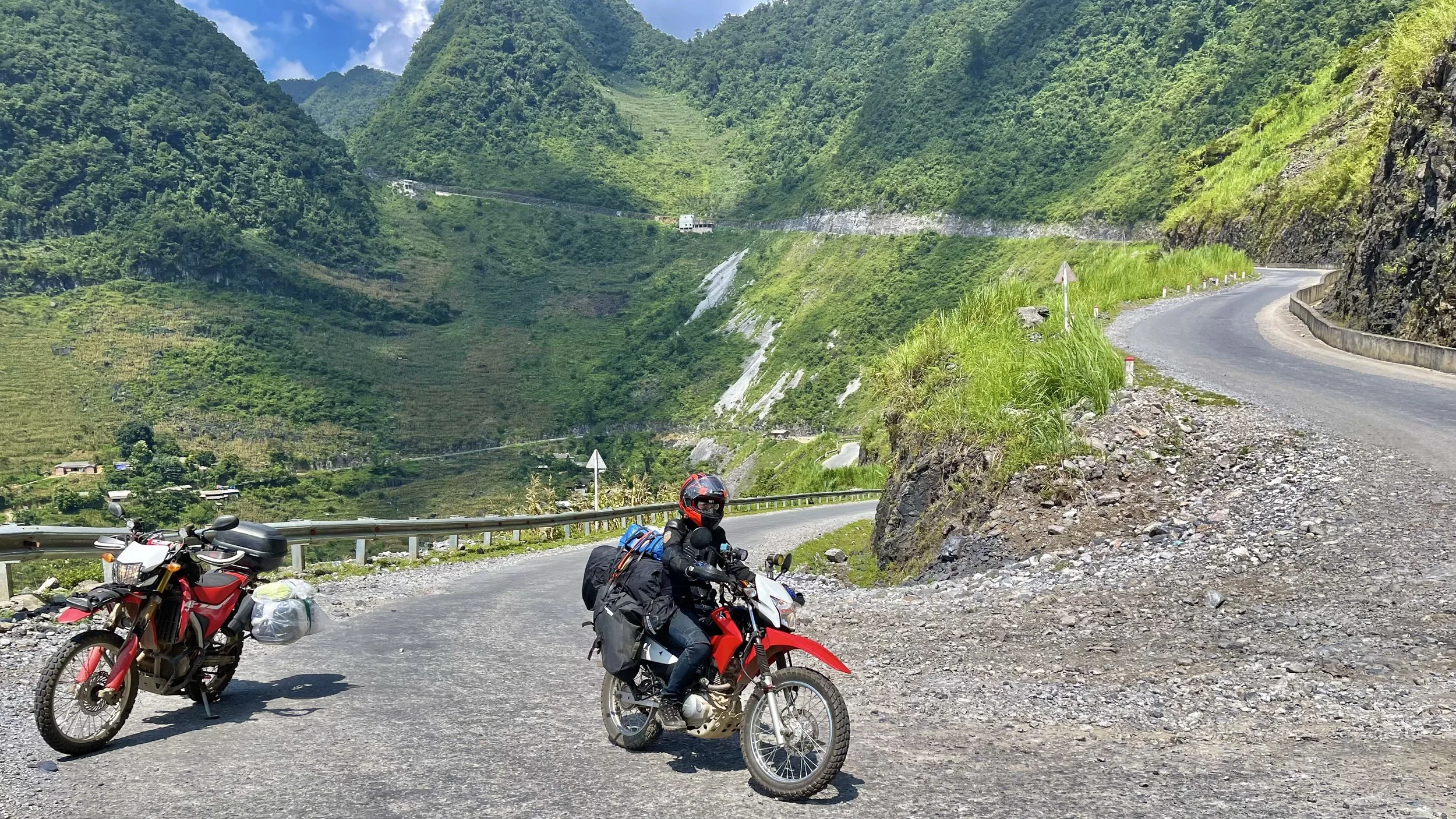 Motorbike rider navigating a winding mountain road on the Ha Giang Loop in northern Vietnam