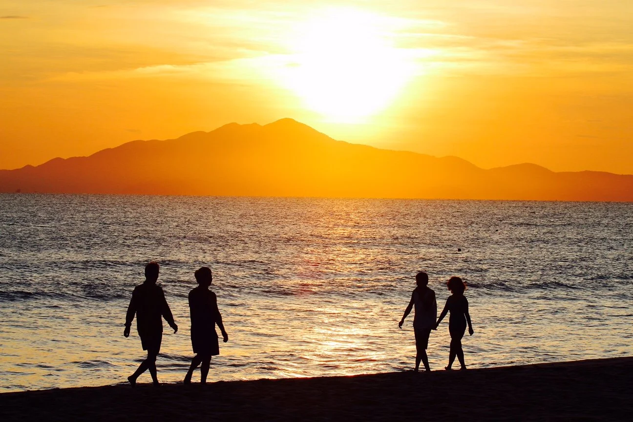 Sunrise over cham Island.  Early morning in Hoi An sees bustling beaches with locals doing their morning exercises.