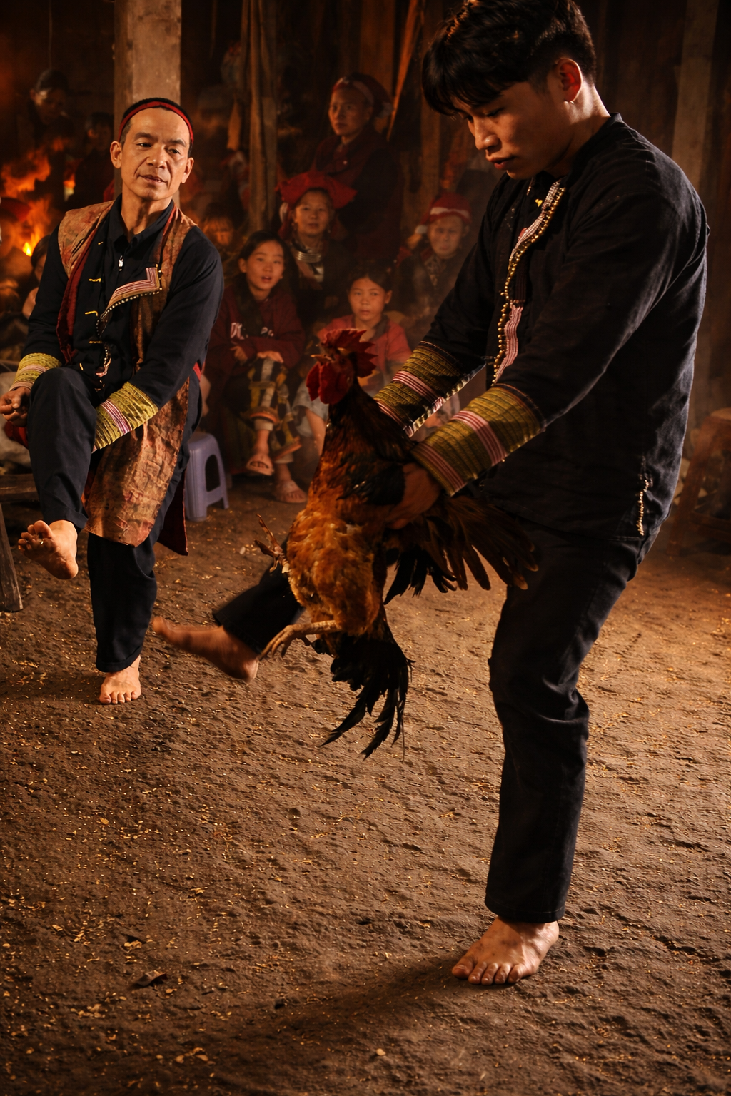 Red Dao ritual master guiding an apprentice during a traditional initiation ceremony in Sa Pa, Vietnam.
