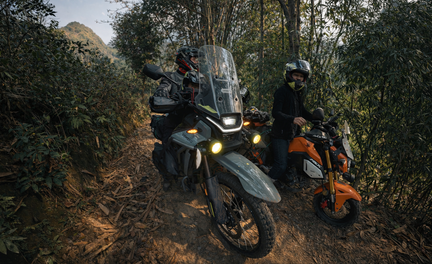 Motorbike riders navigating a narrow forest trail in Lai Chau Province, highlighting off-road conditions in remote northern Vietnam