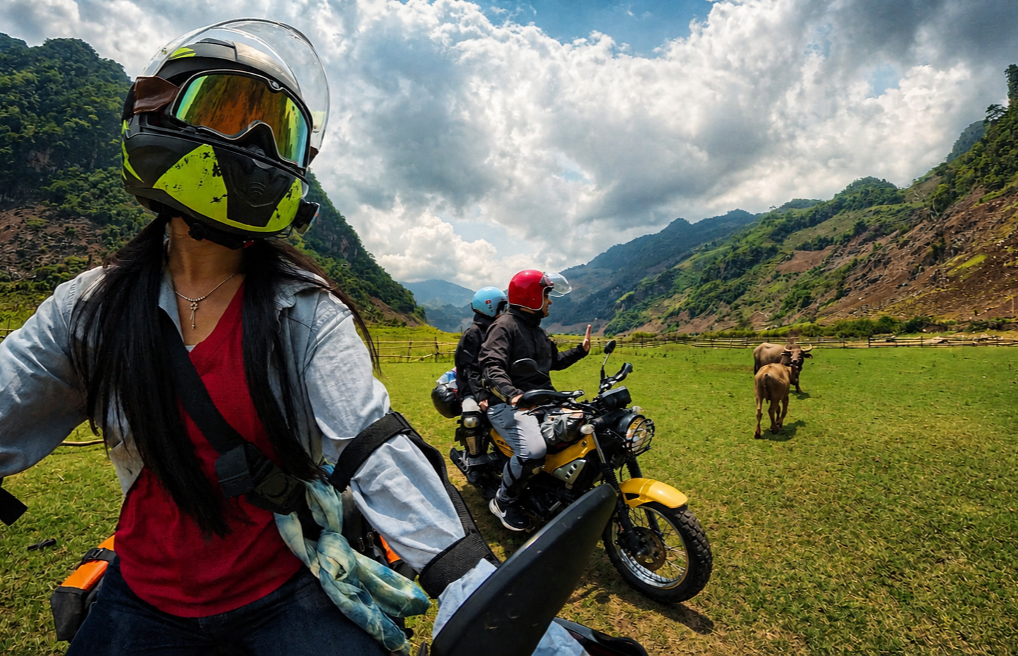 Motorbike riders travelling off-road through a rural valley in Son La Province with mountainous terrain in northern Vietnam