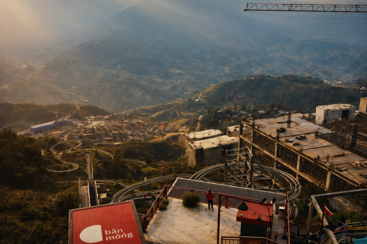 Panoramic view of Sapa mountains with cable car station and winding tracks across the valley