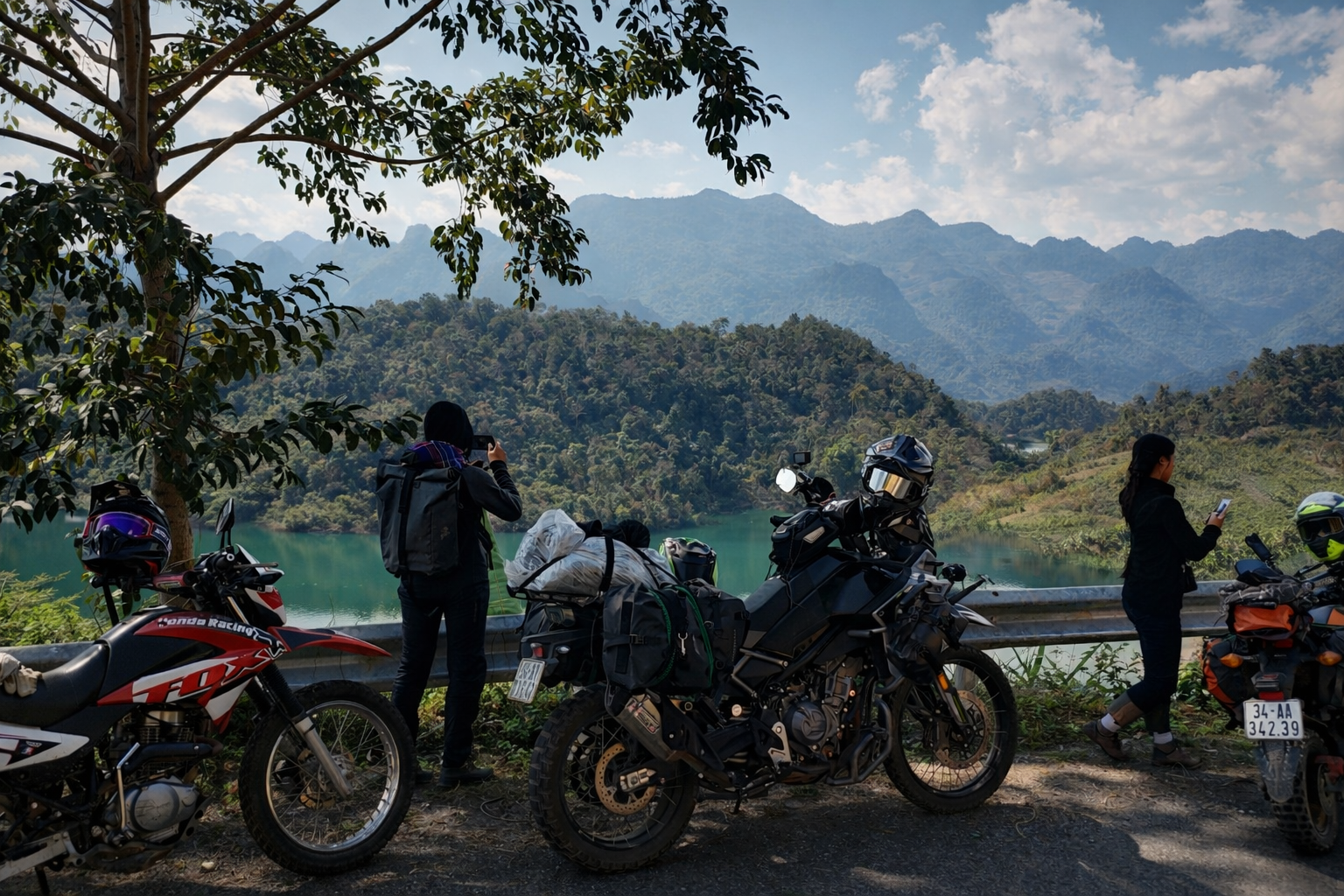Travellers with motorbikes stopping at a scenic viewpoint overlooking the mountain valleys of northern Vietnam.