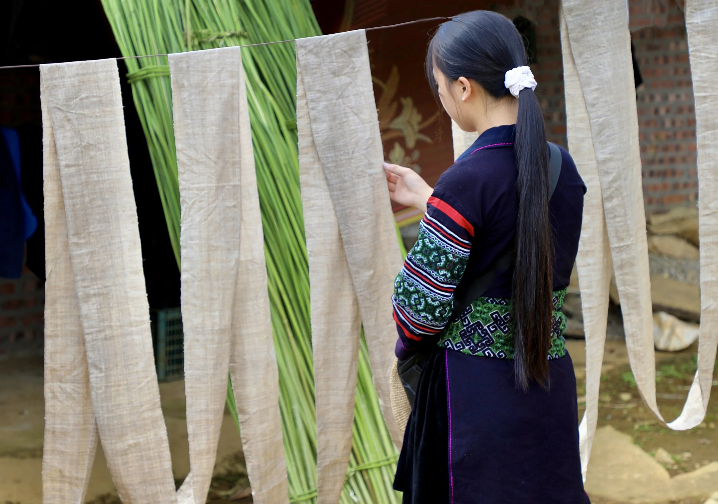 Handwoven hemp fabric hanging to dry in a village in Sapa