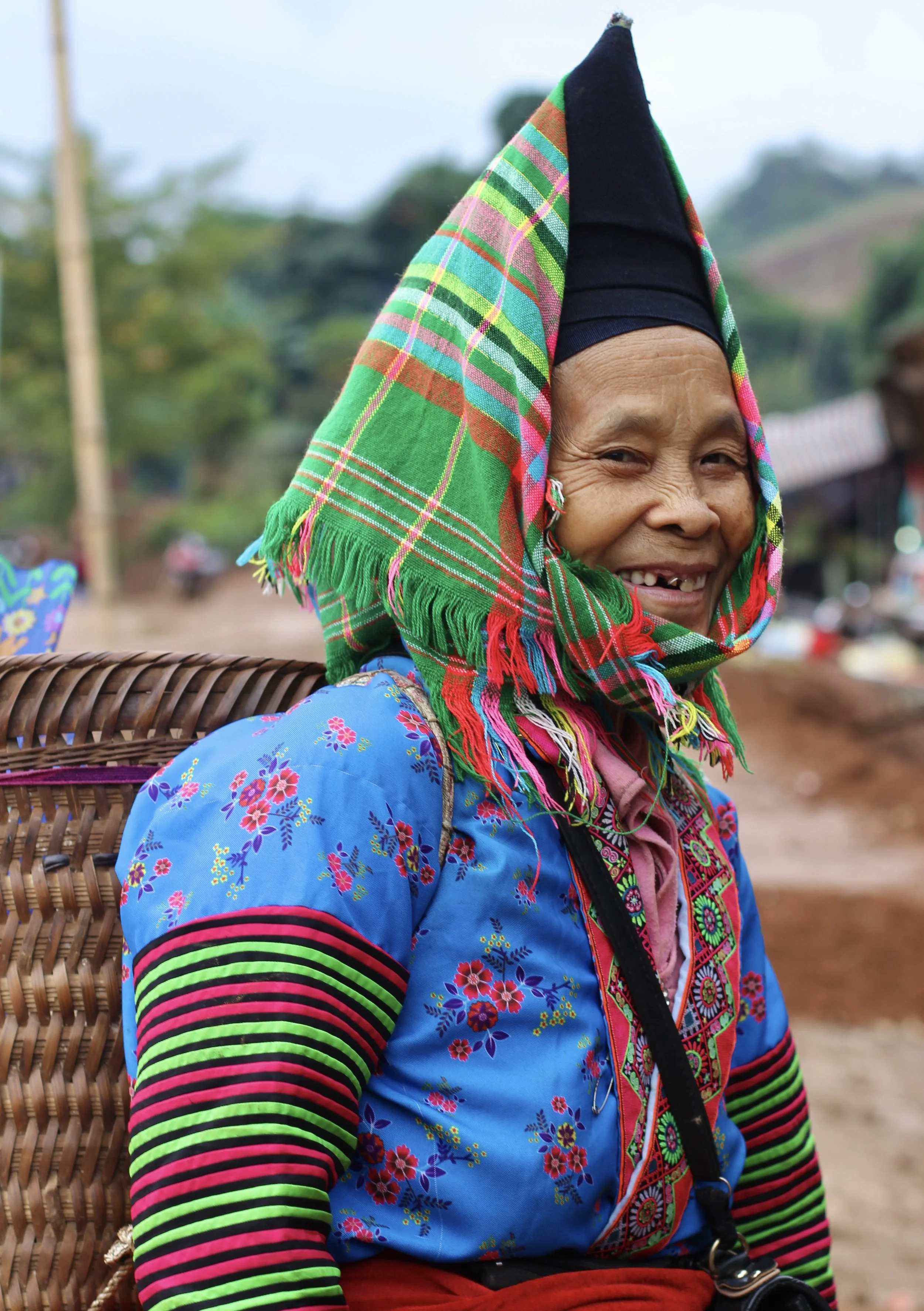 Ethnic minority woman in traditional colourful attire during Northwest Loop car journey in northern Vietnam