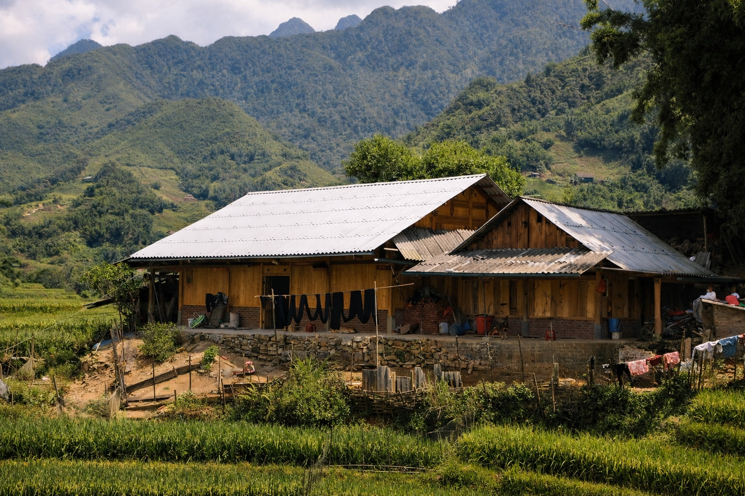 Traditional Hmong home with indigo-dyed fabrics drying outside in the Sapa mountains.
