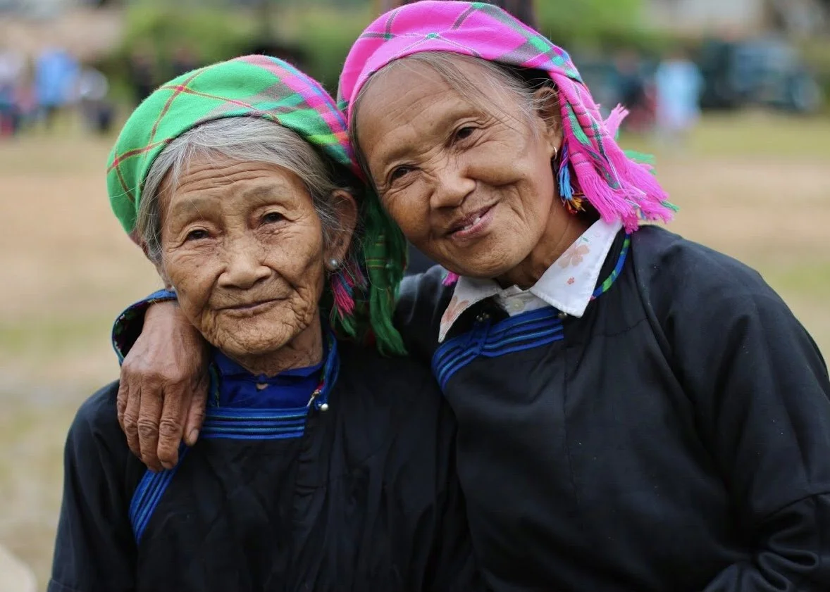 Two Tày women wearing traditional clothing in a remote community in Lào Cai Province, Northern Vietnam.