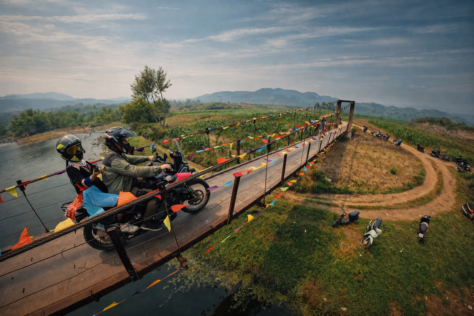 Motorbike riders crossing a narrow suspension bridge in Lai Chau Province showing remote access routes in northern Vietnam