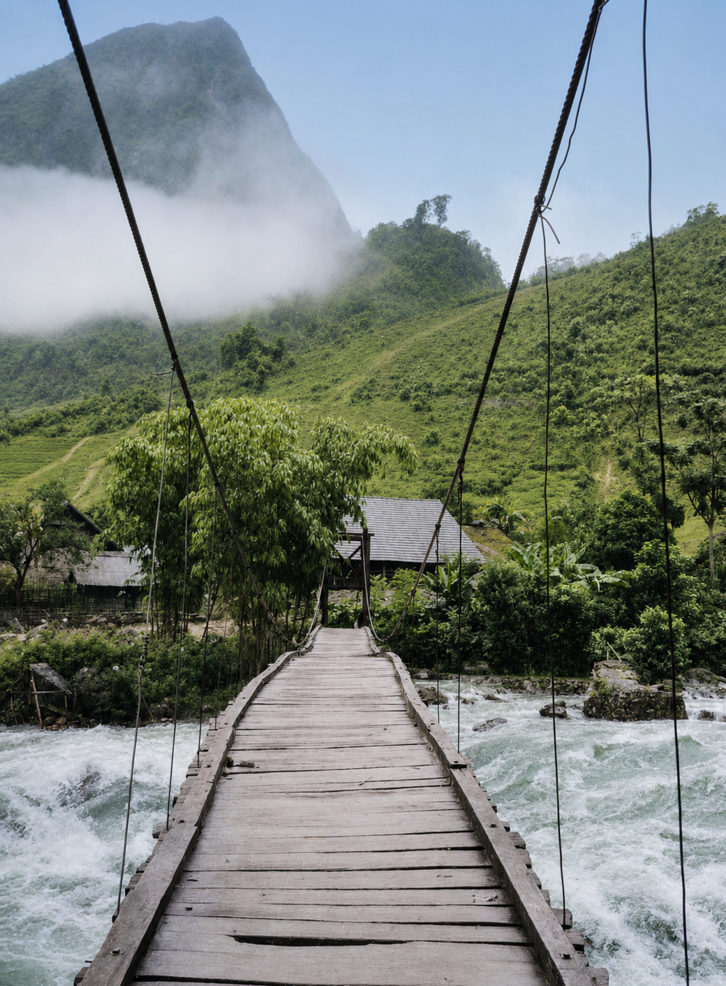 Wooden suspension bridge crossing a mountain river near Sapa, Vietnam, in 1998.