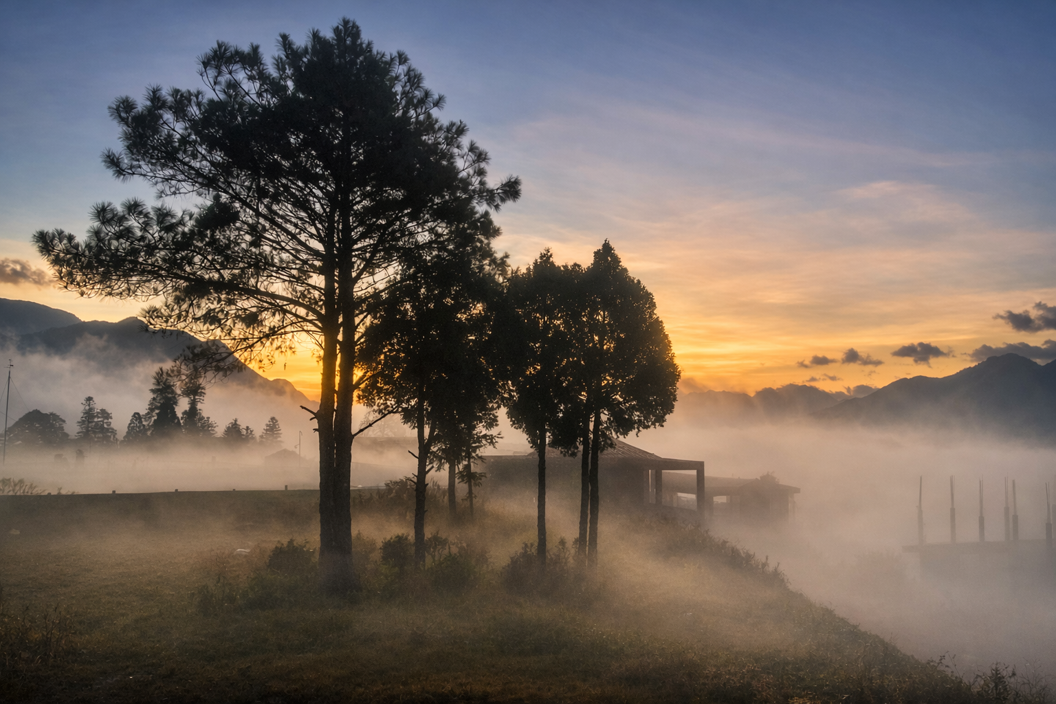 Sunrise over misty mountains and trees in the countryside near Sapa.
