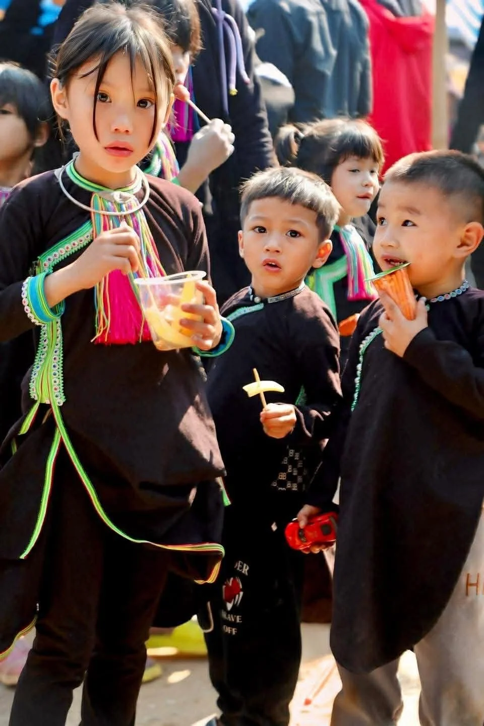 Ethnic minority children enjoying drinks at a Tet market in Northern Vietnam