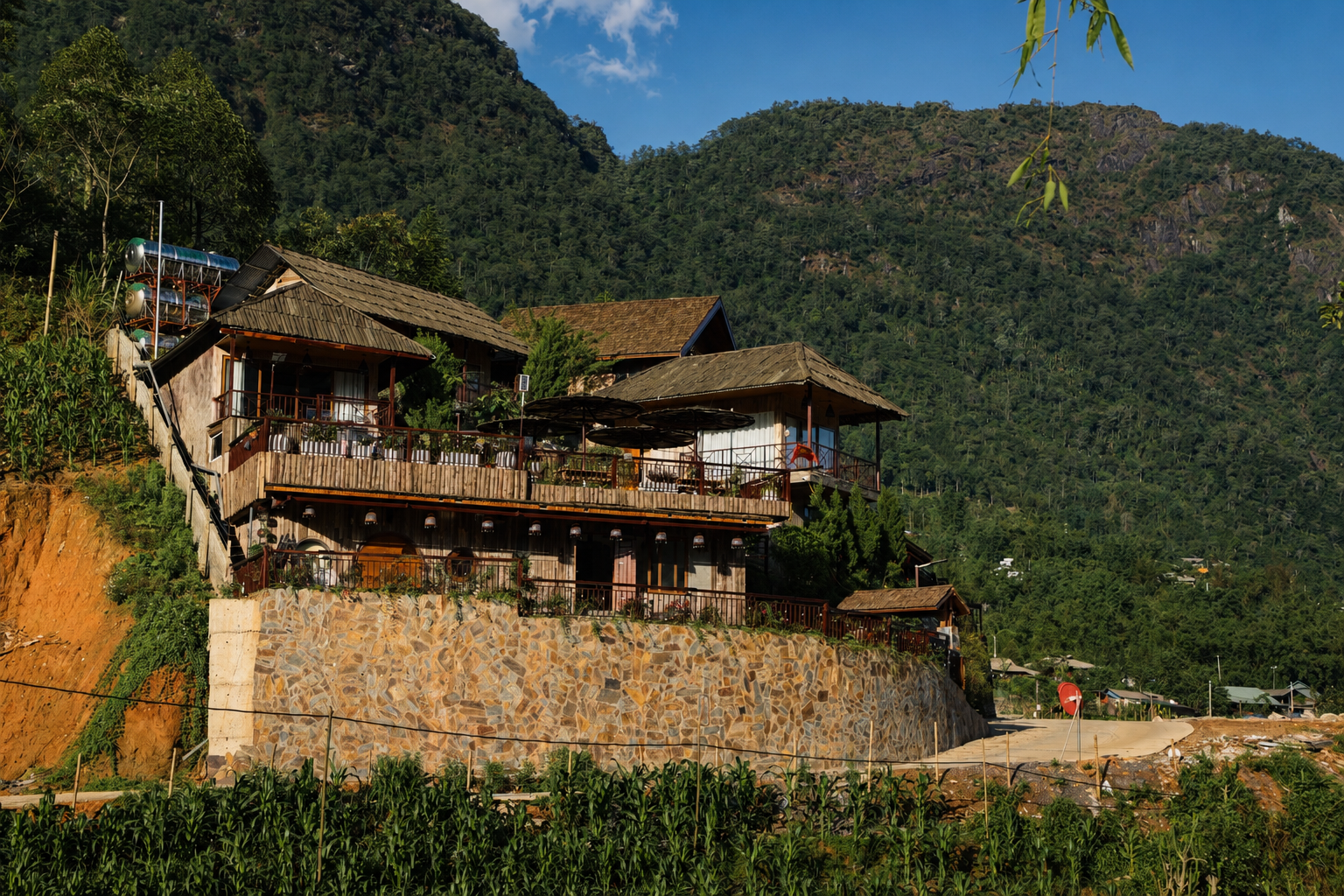 Modern hillside accommodation overlooking the Sapa valley with architecture inspired by local building styles.
