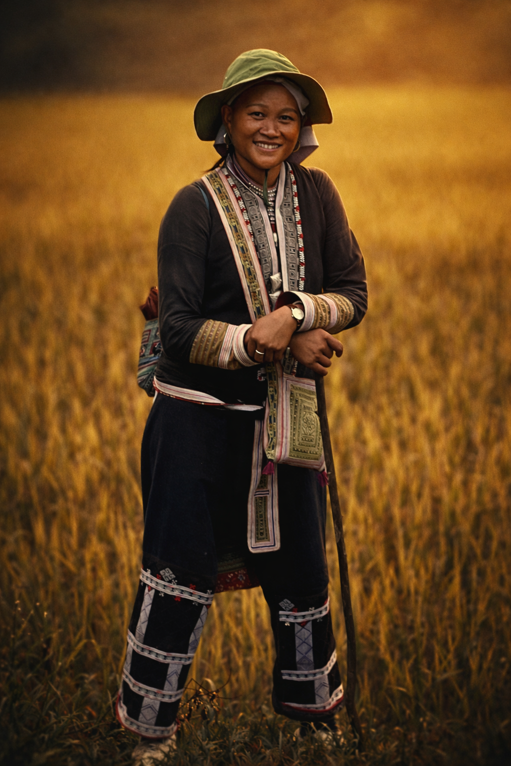 Red Dao woman and ETHOS guide standing in golden rice fields in Sapa, representing living culture and community-led tourism