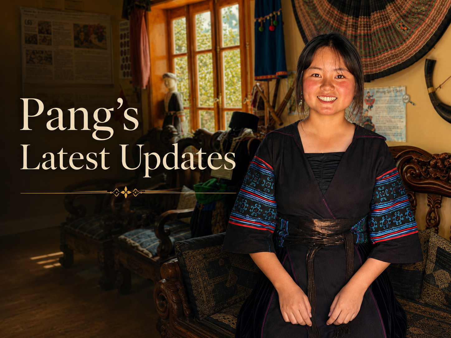 Pang smiles in traditional Black Hmong clothing while standing inside a room displaying local textiles and cultural objects.
