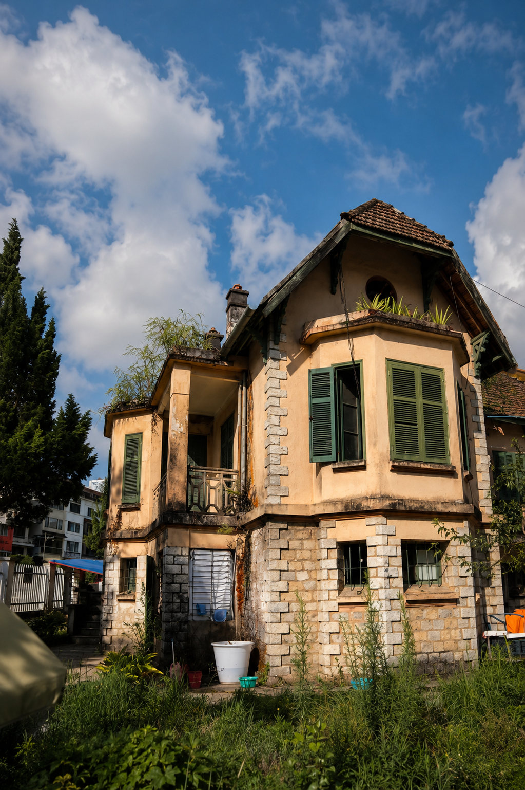 Photograph of a preserved French colonial-era stone villa with shuttered windows in Sapa, taken in 2026.