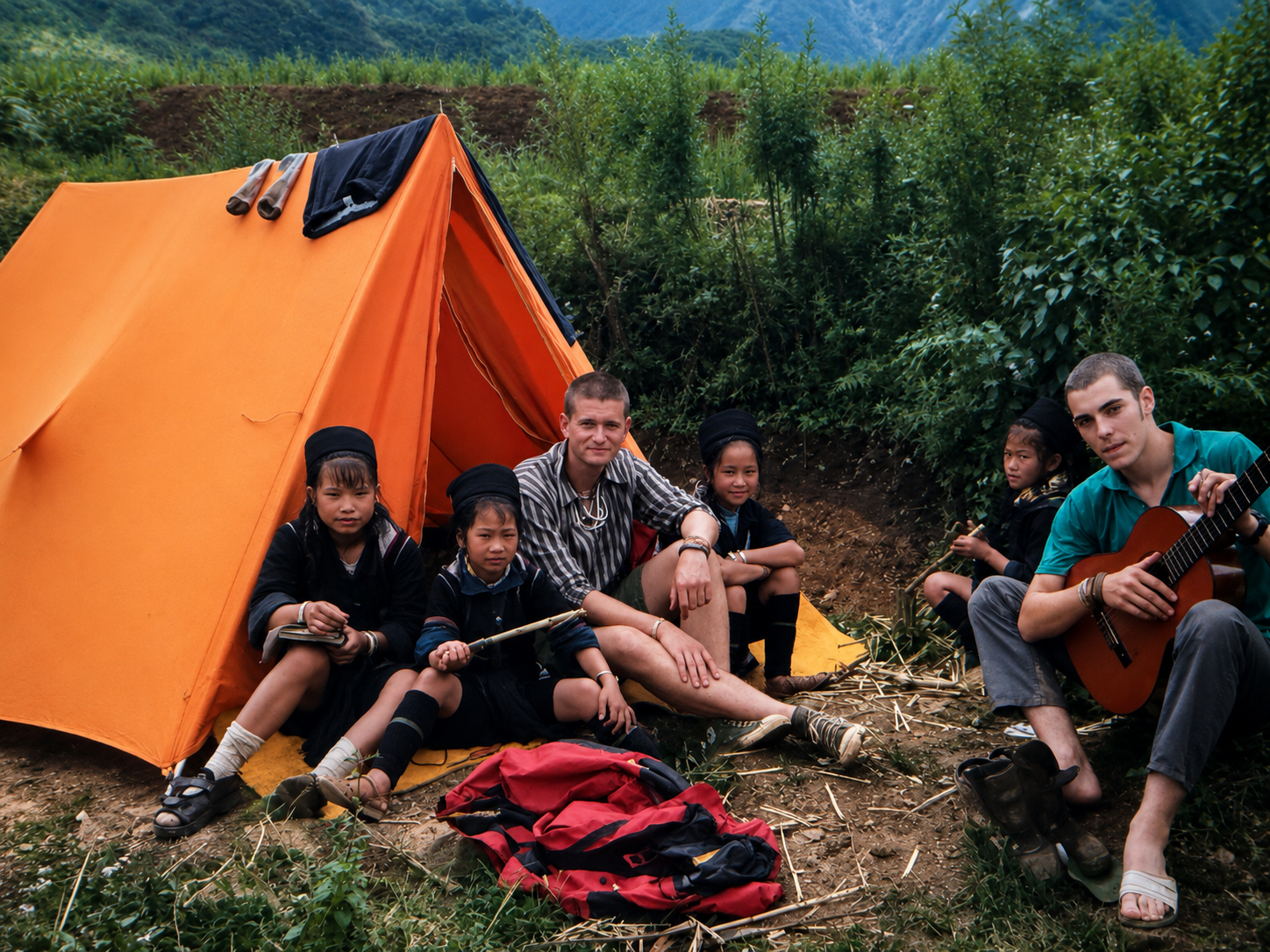 Frontier research team sitting outside a mountain base camp with Hmong children near Sapa, Vietnam, during a 1998 biodiversity expedition.