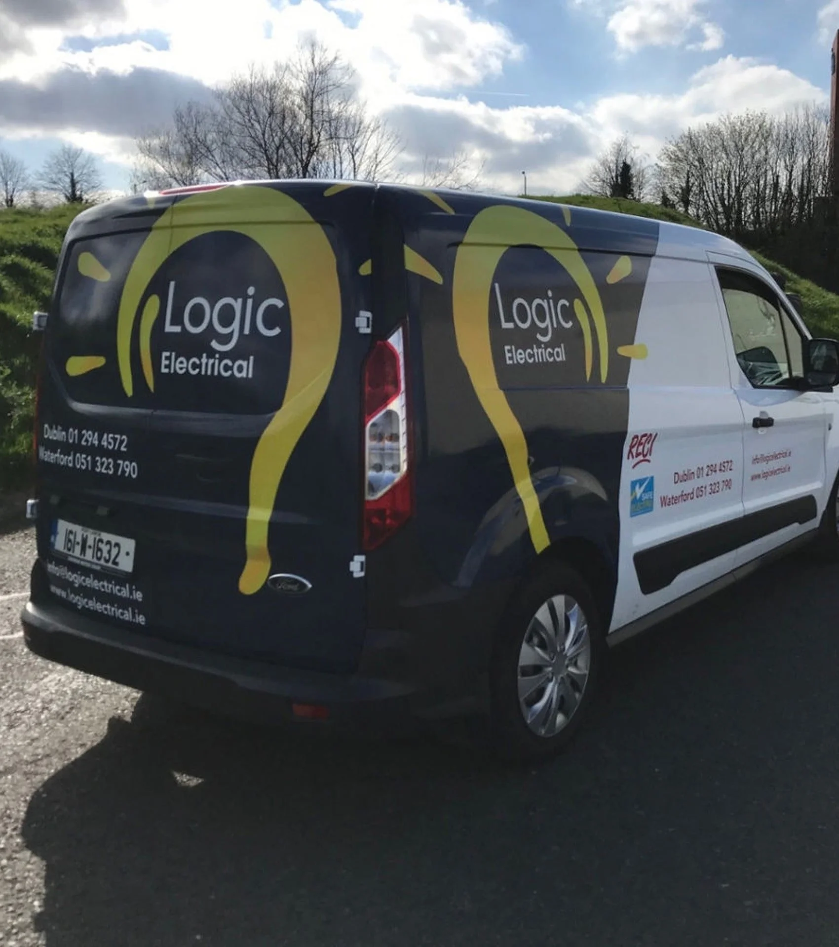 A company van for Logic Electrical, with branding and contact information, parked outdoors on a partly cloudy day.