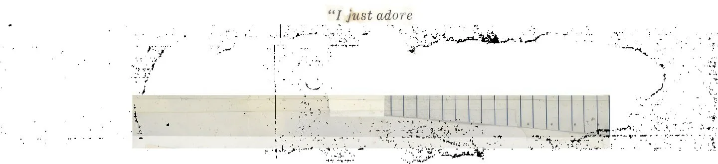 Piece of notebook paper with handwritten text "I just adore" and a small drawing of a heart.