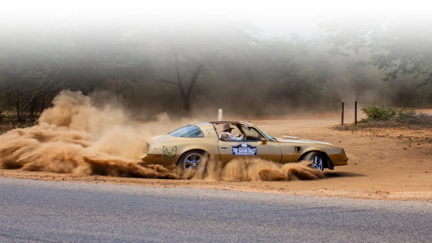 A classic Safari Rally car on a dusty Zimbabwean road