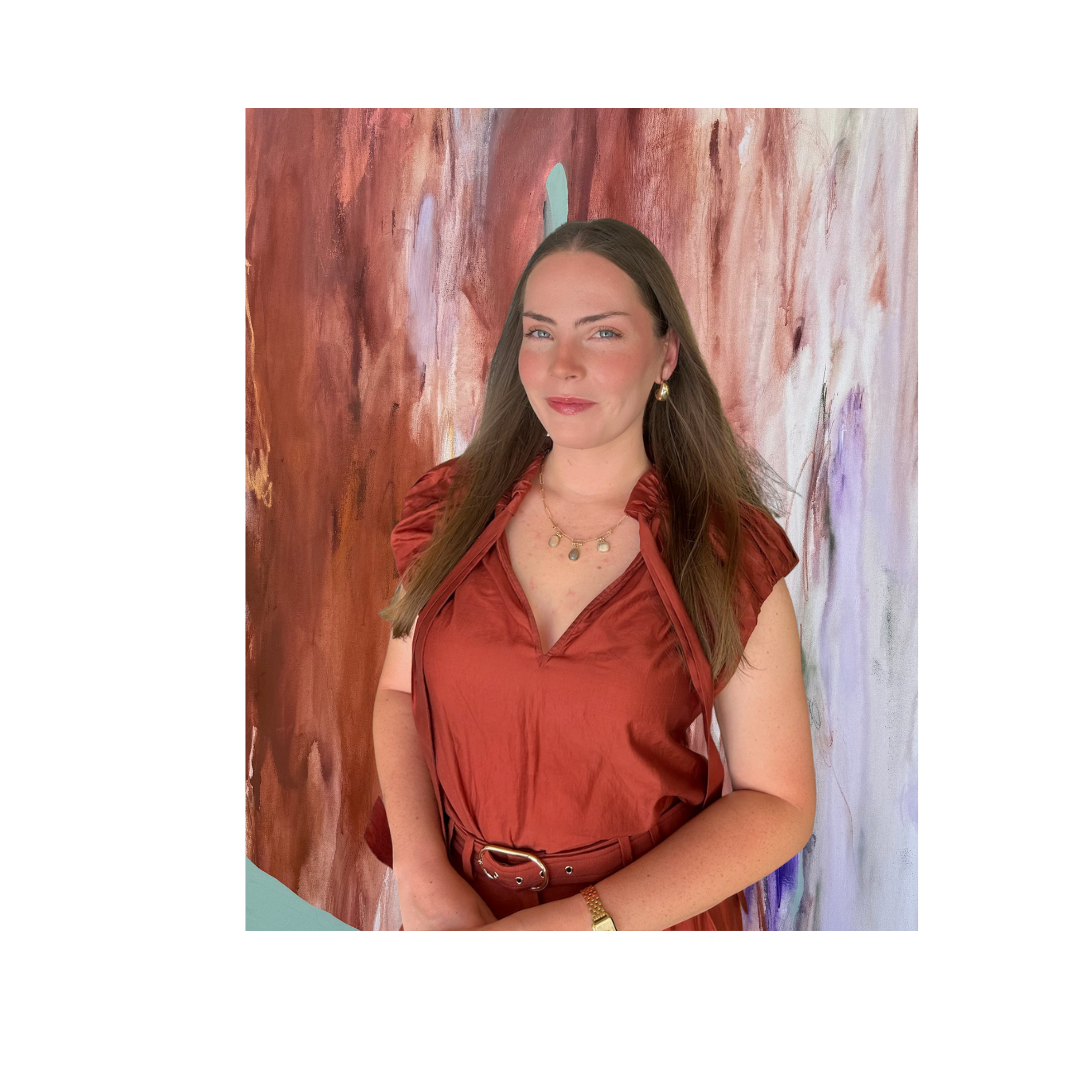 A woman with long brown hair, wearing a rust-colored dress, standing in front of an abstract, multicolored background.