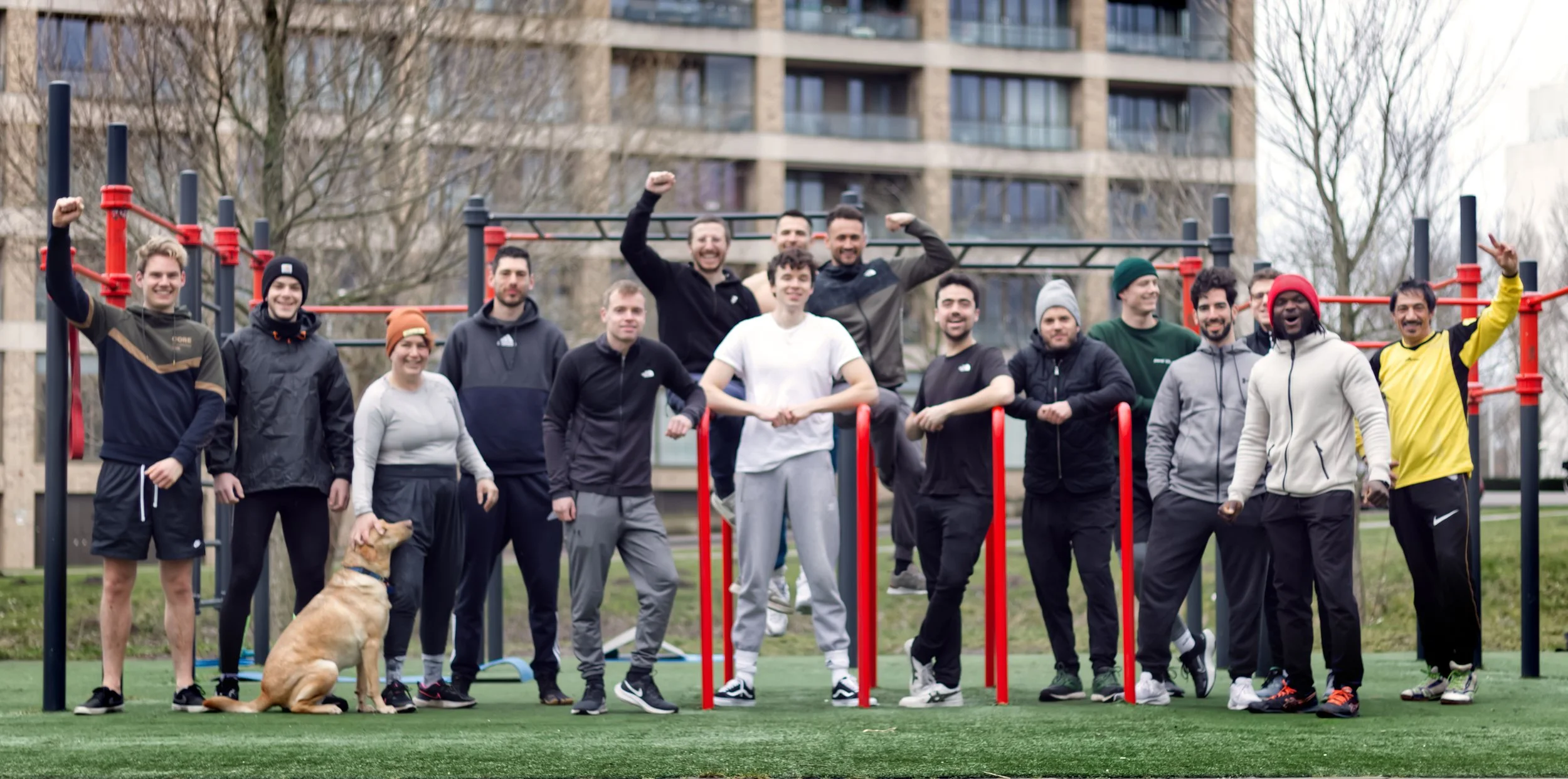 a bunch of men training in a group at the calisthenics park in amsterdam west