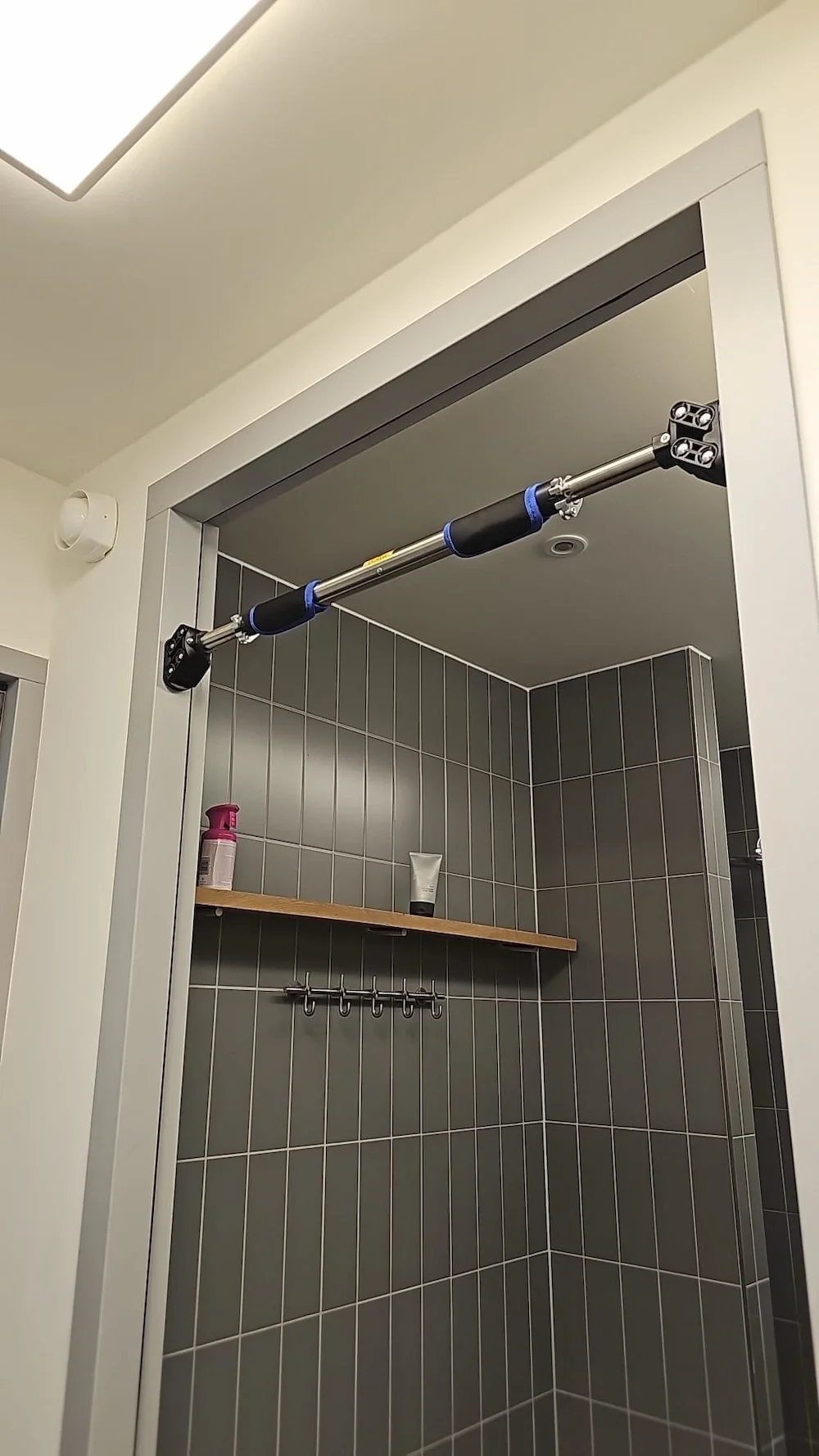 a home pull up bar hanging on a doorframe.webp