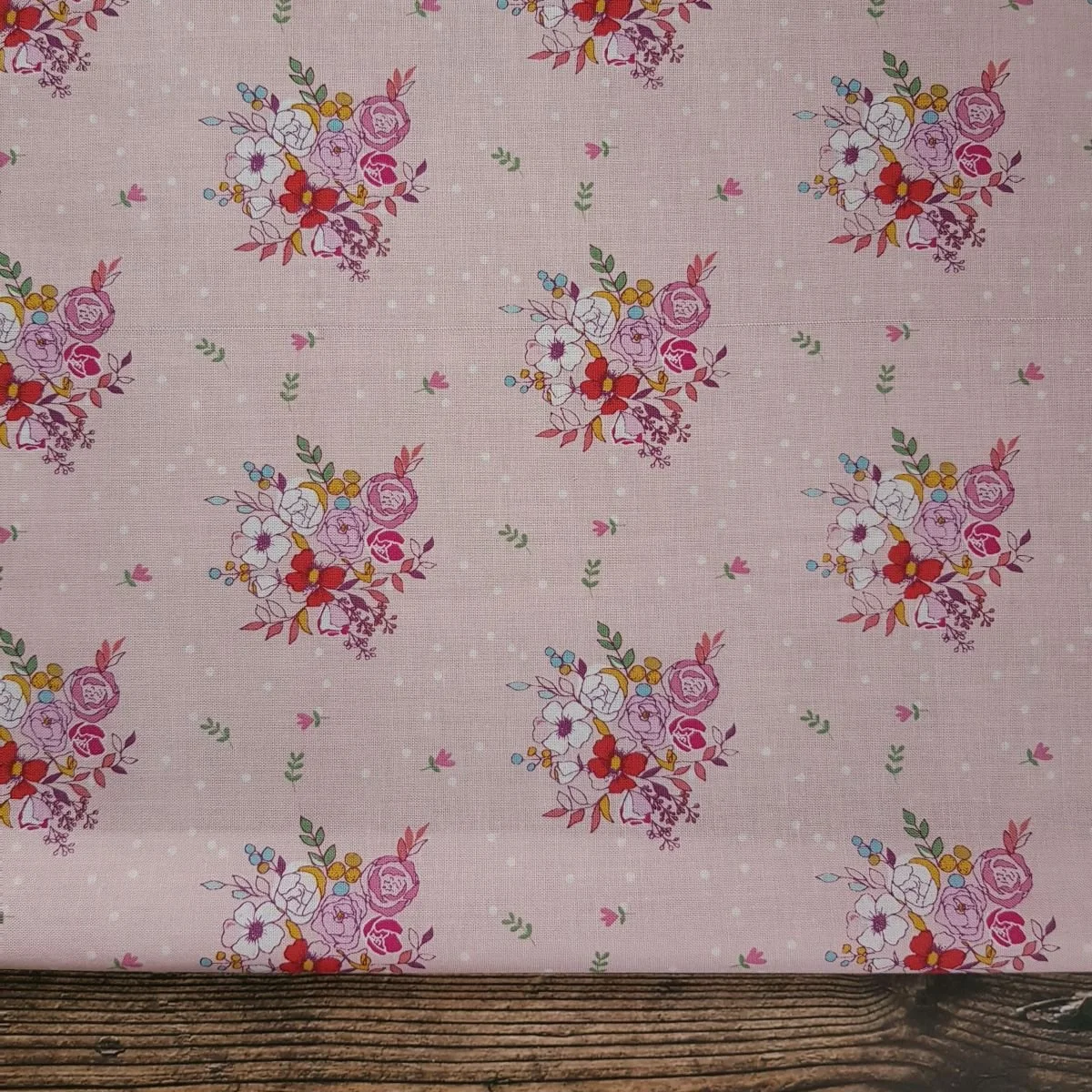 Baby pink cotton fabric with flowers in white, red and pink