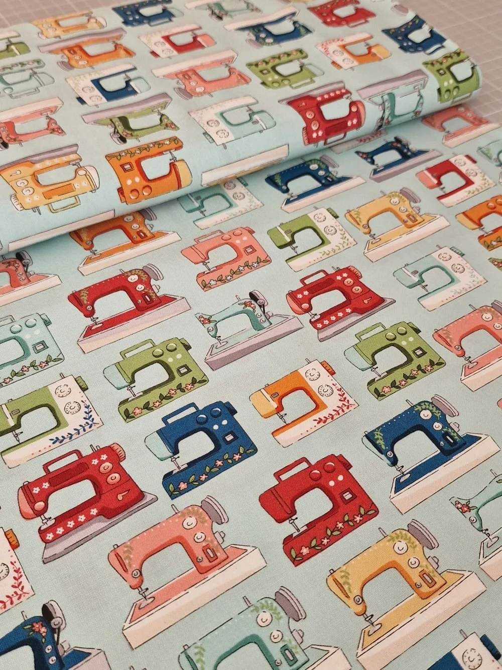 Makower Sewing Room cotton fabric with sewing machines on blue.