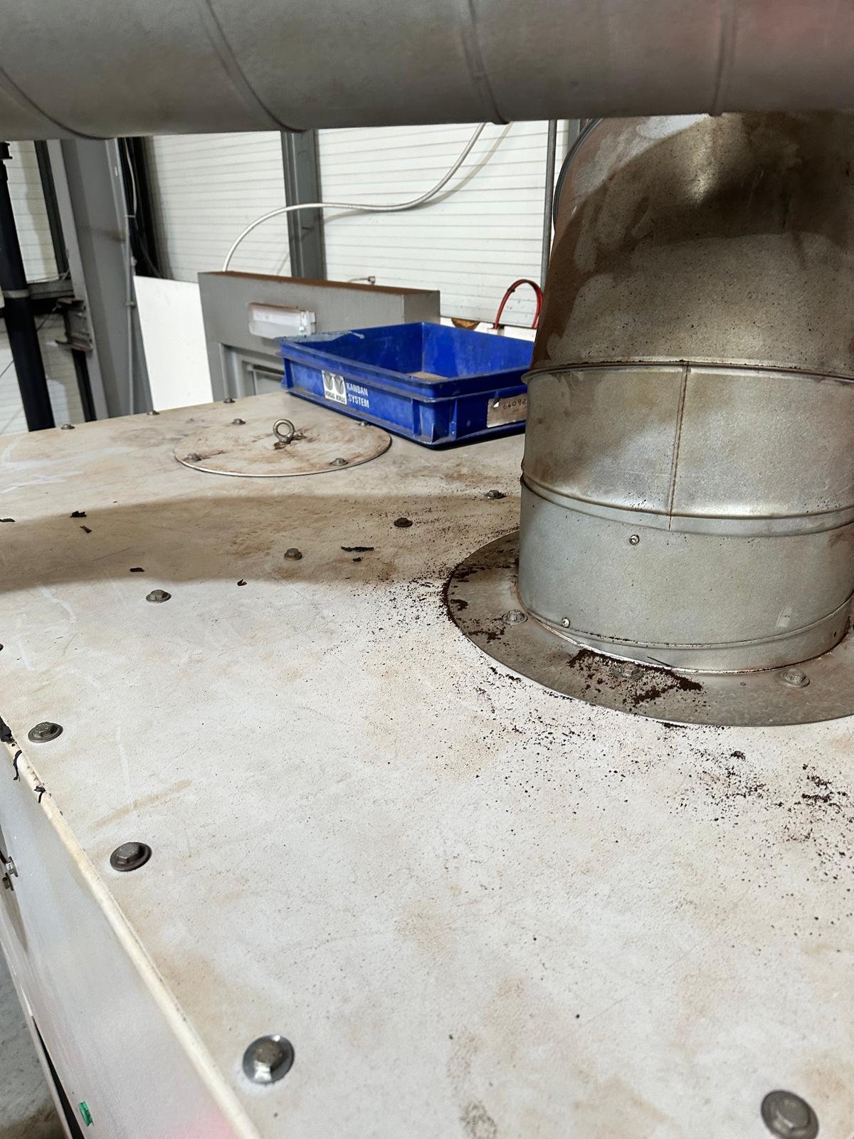Dust deposits around the original extraction duct connection before remedial work