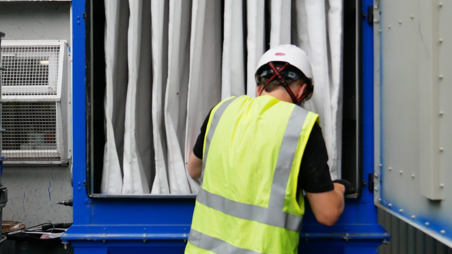 Engineer inspecting filter bags inside an industrial extraction unit