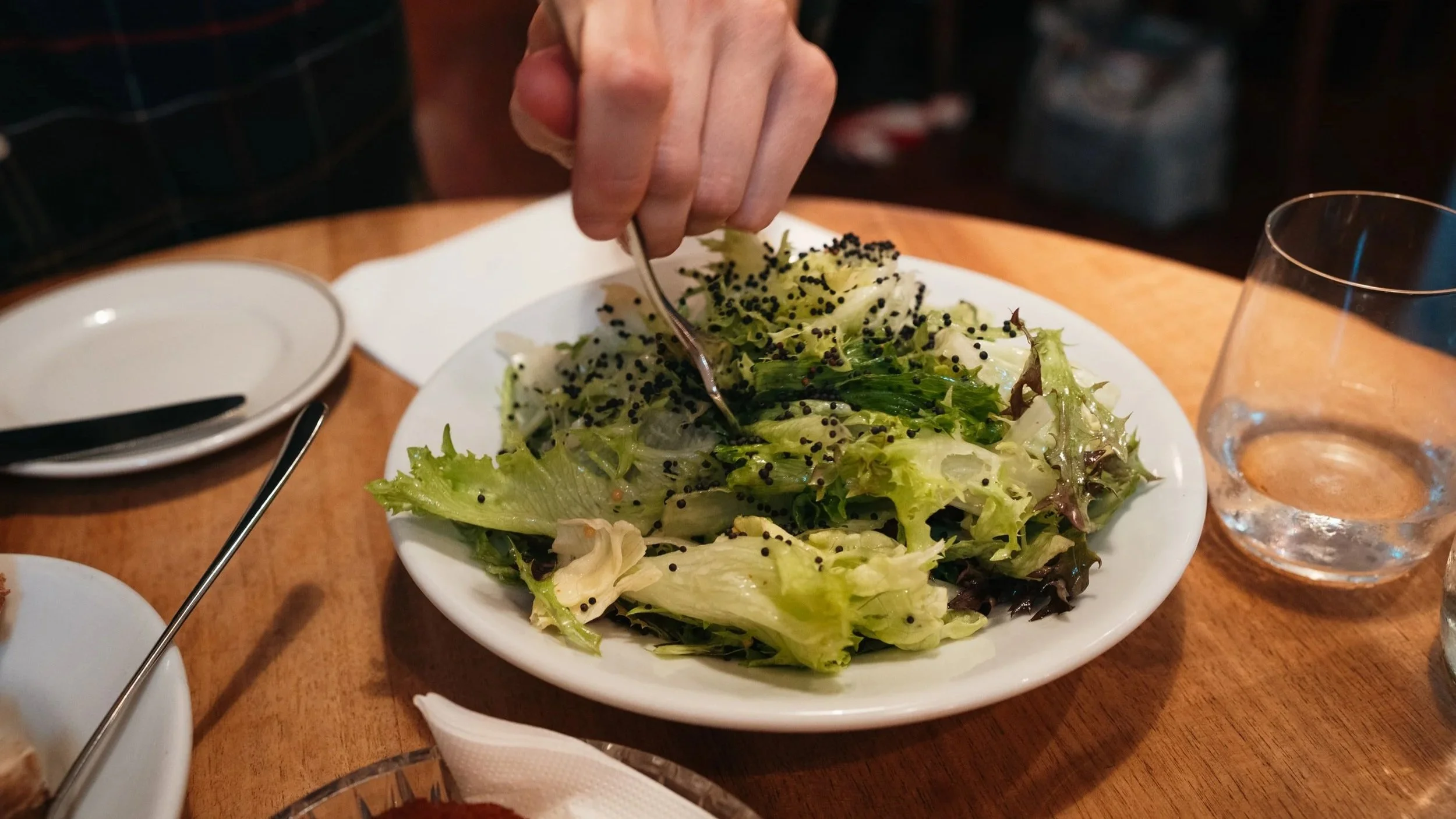 Salad with mustard seed vinaigrette and rapeseed in dinner restaurant Lotti in Zurich, Switzerland.