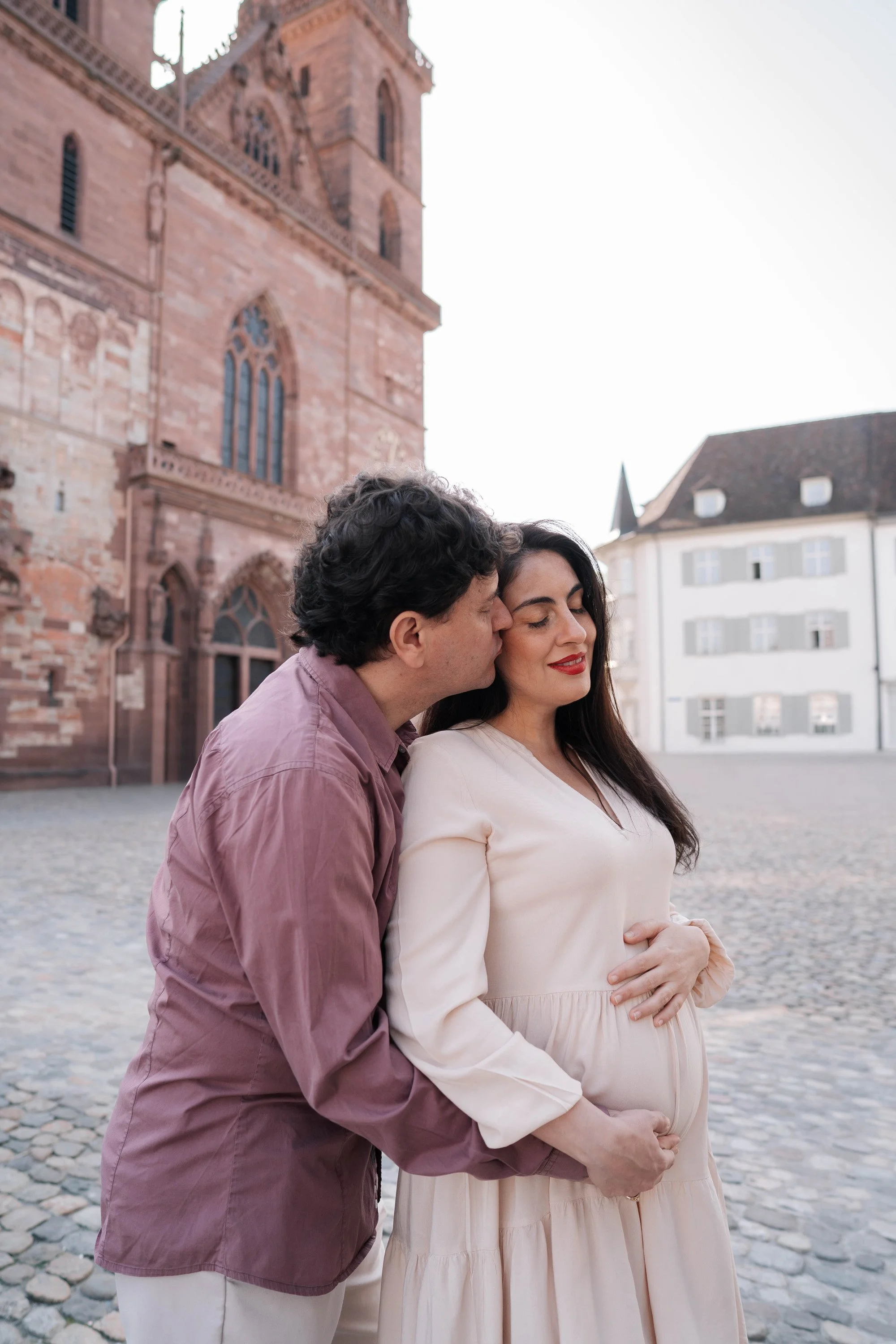 Couple Hugging in front of Basel Cathedral, Switzerland