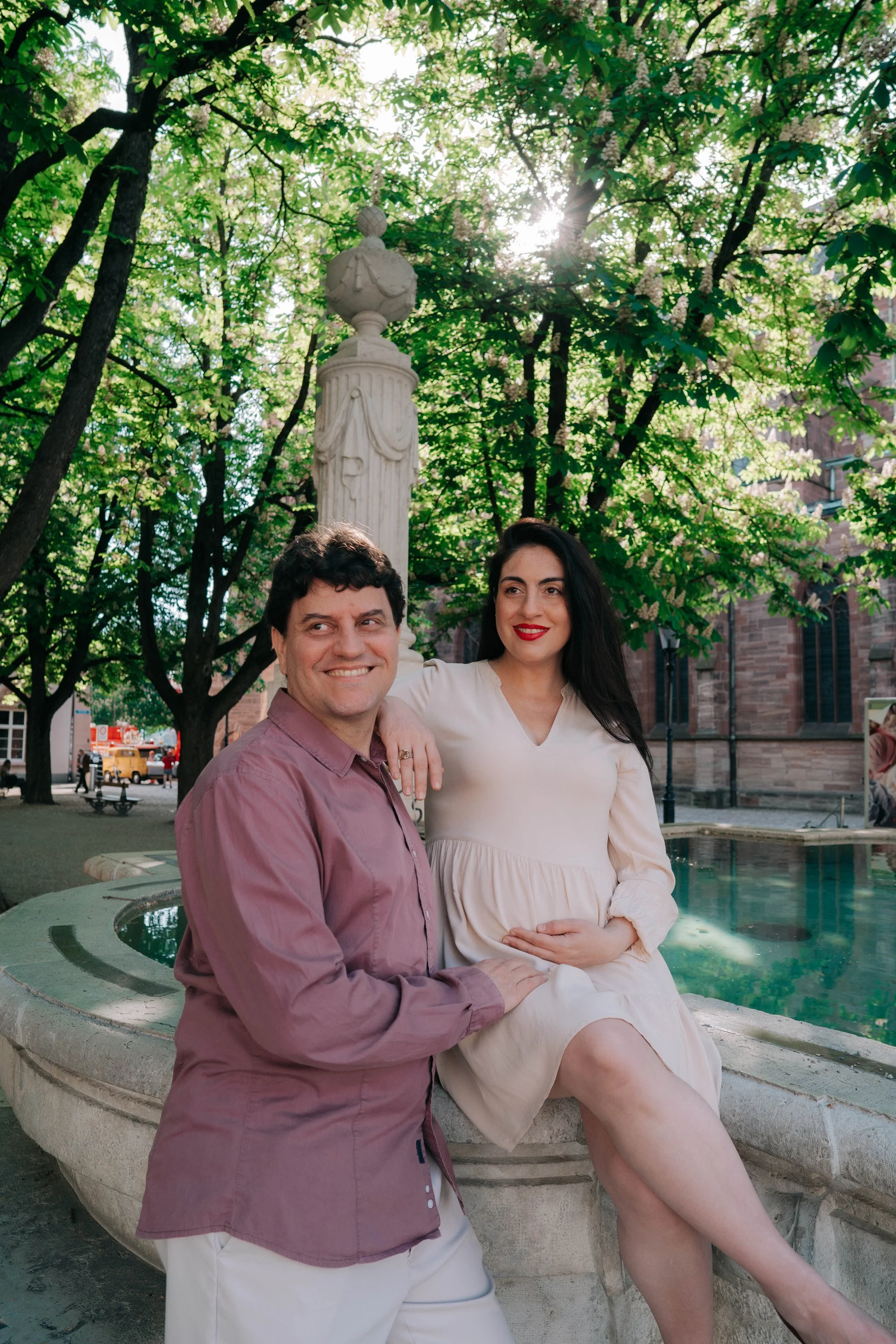 Maternity photoshoot at a historic fountain in Basel old town.
