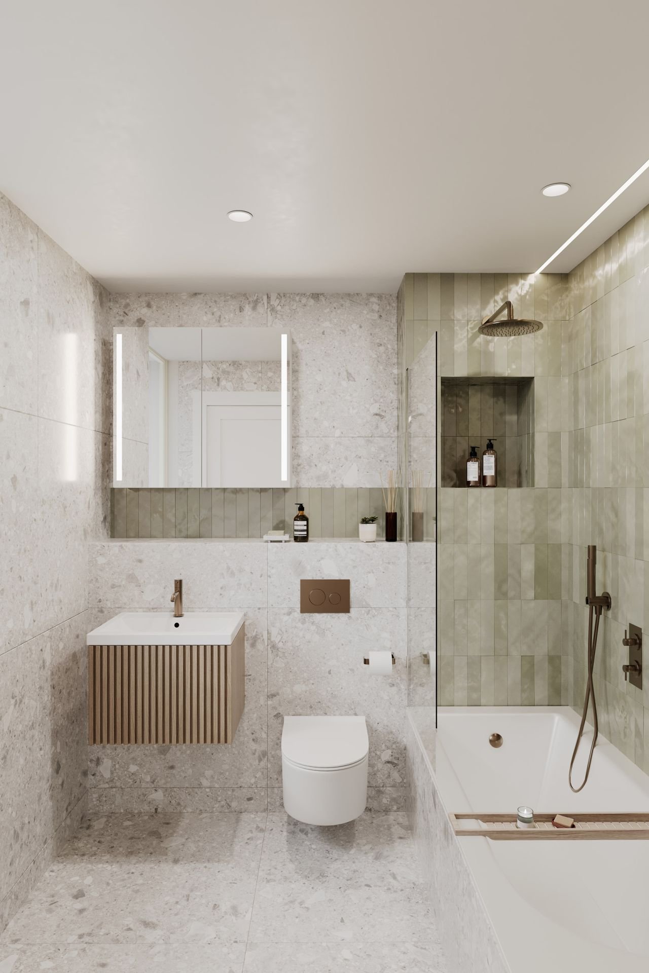 Modern beige and green tiled bathroom with wall-mounted sink, mirror, toilet, and bathtub with handheld shower