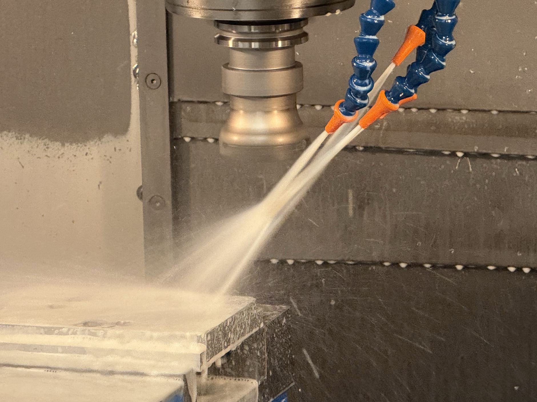 Odin CNC mill machining an in-house part with coolant at Ricks Machining in Logan, Utah.