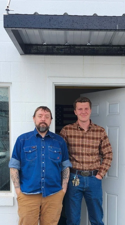 Team members at the entrance to the Ricks Machining CNC machine shop.